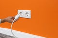 Man plugging cord into a electrical outlet Royalty Free Stock Photo