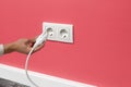 Man plugging cord into a electrical outlet Royalty Free Stock Photo