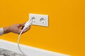 Man plugging cord into a electrical outlet Royalty Free Stock Photo