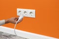 Man plugging cord into a electrical outlet Royalty Free Stock Photo