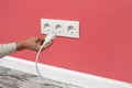 Man plugging cord into a electrical outlet Royalty Free Stock Photo