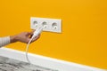 Man plugging cord into a electrical outlet Royalty Free Stock Photo