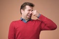 Man plugs nose as smells something stink