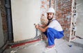 Man plumber installing heating system in apartment. Royalty Free Stock Photo