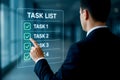 Man pointing at a digital task list with labeled tasks and checkmarks on a futuristic screen checklist Royalty Free Stock Photo