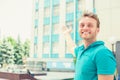 Man pointing in direction of apartment. New apartment in tall building