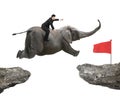 Man with pointing finger riding elephant flying toward red flag Royalty Free Stock Photo