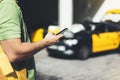 Man pointing finger on screen smartphone on background yellow taxi, tourist hipster using in hands mobile phone, person connect wi Royalty Free Stock Photo