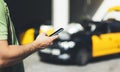 Man pointing finger on screen smartphone on background yellow taxi, tourist hipster using in hands mobile wifi phone, person Royalty Free Stock Photo