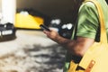 Man pointing finger on screen smartphone on background yellow taxi, tourist hipster using in hands mobile phone, person connect Royalty Free Stock Photo