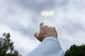 Man pointing finger at the strange lights in the sky, three light orbs among the clouds