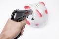 Man pointing a gun at a piggy bank no white background Royalty Free Stock Photo