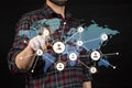 a man pointing with his index finger to a networking concept world map Royalty Free Stock Photo
