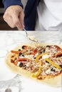 Man pointing at homemade pizza before baking in the oven Royalty Free Stock Photo