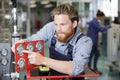 Man pointing at machine valves Royalty Free Stock Photo