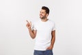 Man pointing showing copy space isolated on white background. Casual handsome Caucasian young man. Royalty Free Stock Photo