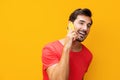 Smartphone man portrait communication smiling phone yellow space studio mobile copy happy cyberspace phone Royalty Free Stock Photo