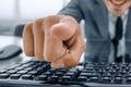 man pointing at something with finger and using computer keyboar Royalty Free Stock Photo