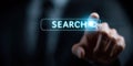 A man is pointing to a search button on a computer screen Royalty Free Stock Photo