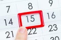 The man points his finger to the date and the calendar is the 15th, close-up. Deadline Royalty Free Stock Photo