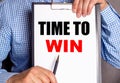 The man points with a pen to the phrase TIME TO WIN on a white sheet Royalty Free Stock Photo