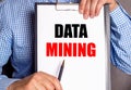 The man points with a pen to the text DATA MINING on a white sheet Royalty Free Stock Photo