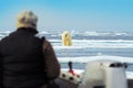 Man with polar bear, dangerous situation in the sea. Human in the Arctic nature. Polar bear on drift ice edge with snow and water