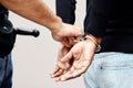Man, police and handcuffs on criminal for arrest, crime or justice in theft, robbery or violence in city. Closeup of Royalty Free Stock Photo