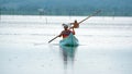 Man poling a boat in La Segua Wetland