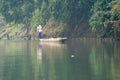 Man Poling a Dugout Canoe