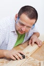 Man polishing wooden planck Royalty Free Stock Photo