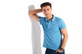Man in polo shirt leaning his elbow on wall Royalty Free Stock Photo