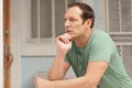 Man pondering on the ledge Royalty Free Stock Photo