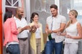 Man popping bottle of champagne with his team