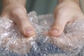 Man popping bubble wrap, closeup view. Stress relief Royalty Free Stock Photo