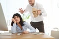 Man popping paper bag behind his sleeping colleague. April fool`s day