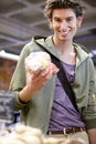 Man, portrait and apple shopping in grocery store for fibre nutrition, vegan food and healthy choice. Male person, smile Royalty Free Stock Photo