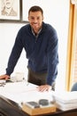 Man, portrait and architect with plan for project in office, documents and drawing on blueprint. Happy male person Royalty Free Stock Photo