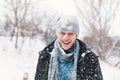 Surprised man feeling cold snowflakes on his face during a snow Royalty Free Stock Photo