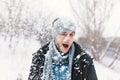 Surprised man feeling cold snowflakes on his face during a snow Royalty Free Stock Photo