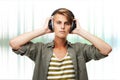 Man, portrait and DJ with headphones or audio waves listening to music against a studio background. Young male person or