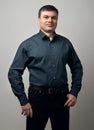 Man portrait dressed in shirt and black pants over gray background Royalty Free Stock Photo