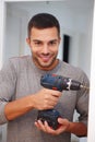 Man, portrait and drill for repair in home, electric tools and handyman service for renovation. Male person, contractor Royalty Free Stock Photo