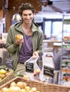 Man, portrait and fruit shopping in grocery store for fibre nutrition, vegan food and healthy choice. Male person, smile Royalty Free Stock Photo