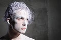 Man portrait with purple hair and flour on a gray background. Royalty Free Stock Photo