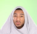 Man, portrait and silly face with disgust for funny smell, self esteem or ego on a green studio background. Shy male Royalty Free Stock Photo