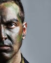 Man, portrait and soldier with face paint for camouflage, military war or battle on a gray studio background. Closeup of Royalty Free Stock Photo