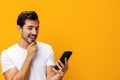 Man portrait technology space smiling happy communication smartphone studio yellow mobile phone cyberspace phone copy Royalty Free Stock Photo