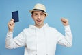 Man portrait tourist with a passport in hand, man in the hat