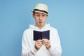 Man portrait tourist with a passport in hand, man in the hat